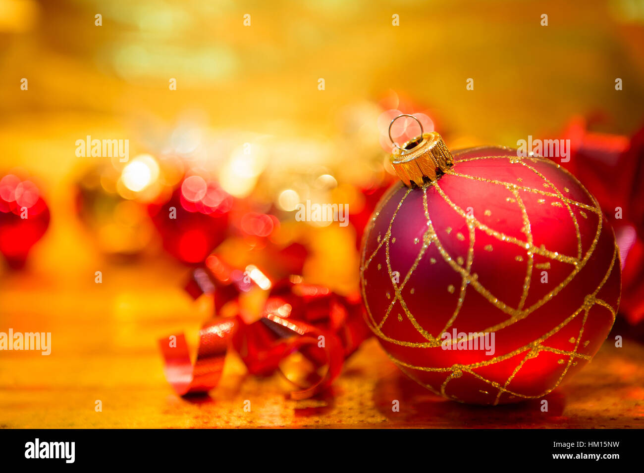 Red Christmas balls on a gold background Stock Photo - Alamy