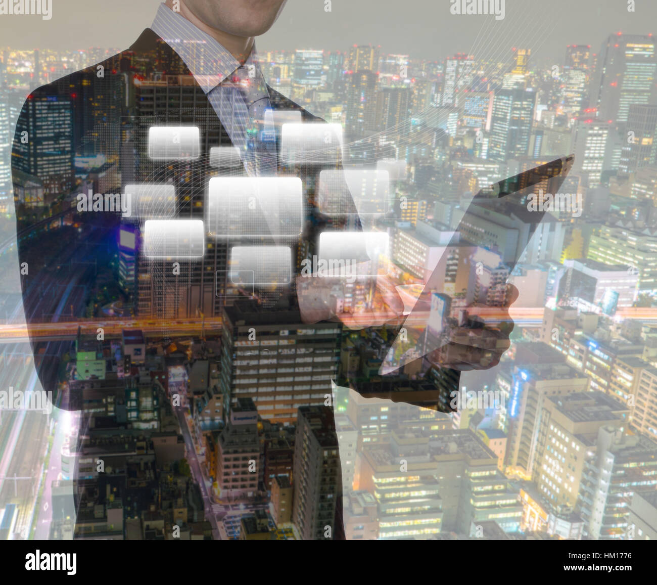 Double exposure of businessman using touch screen device with cityscape ...
