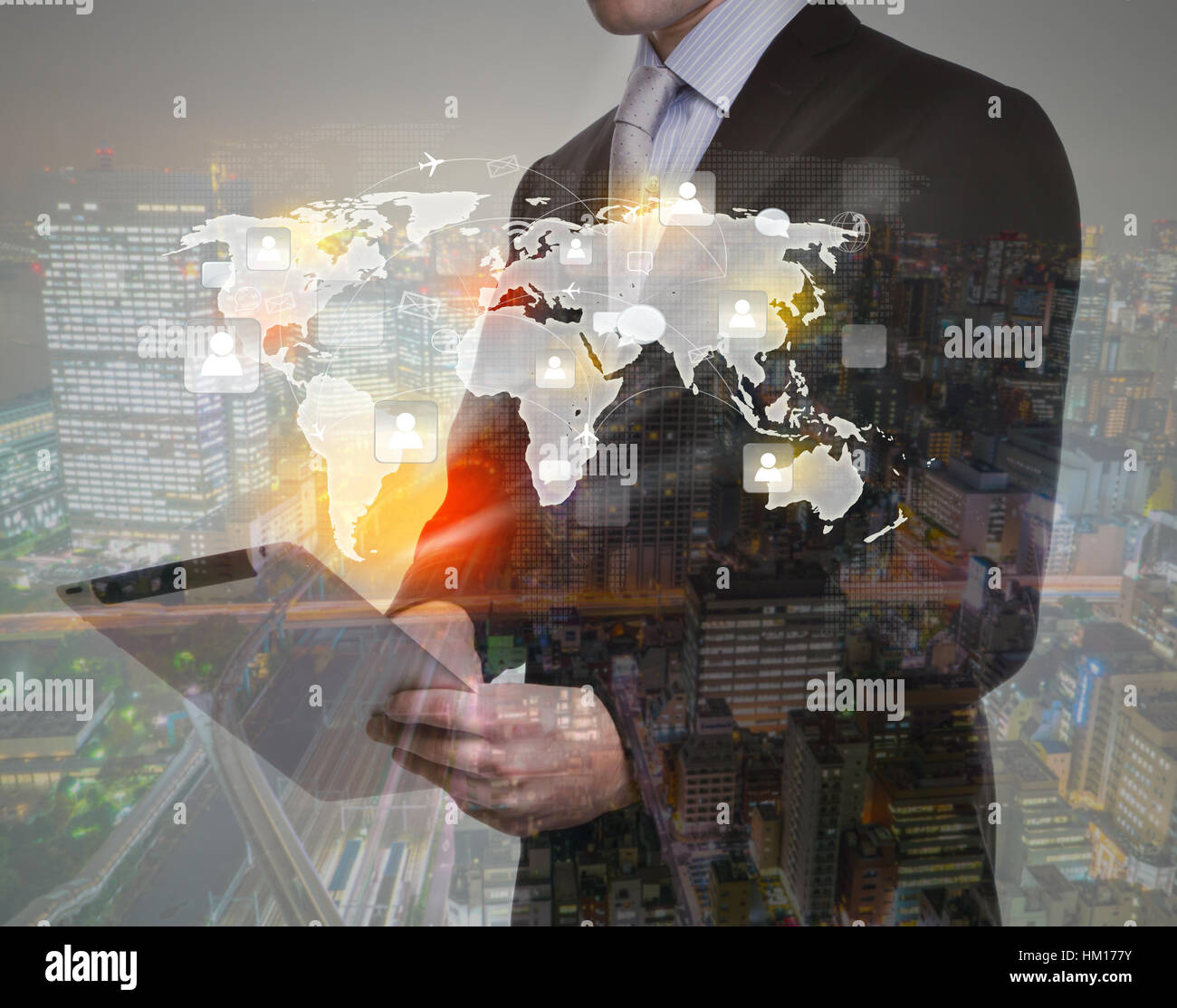 Double exposure of businessman using touch screen device with cityscape ...