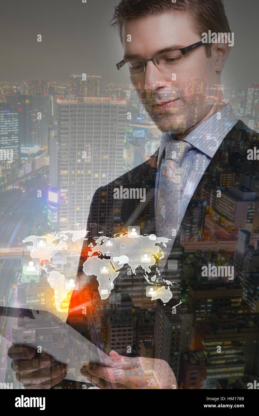 Double exposure of businessman using touch screen device with cityscape ...