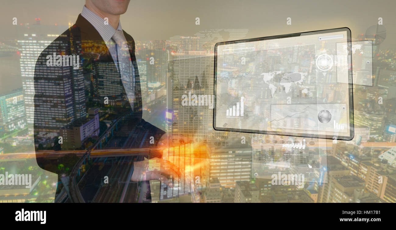 Double exposure of businessman using touch screen device with cityscape ...