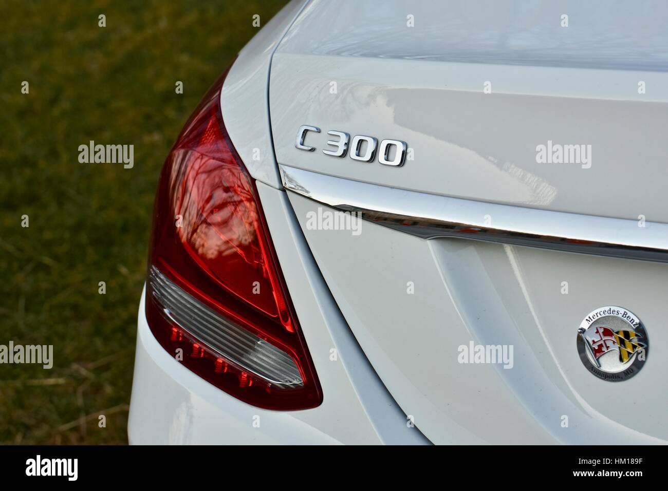 The rear end of a white Mercedes Benz C-300 luxury sedan Stock Photo