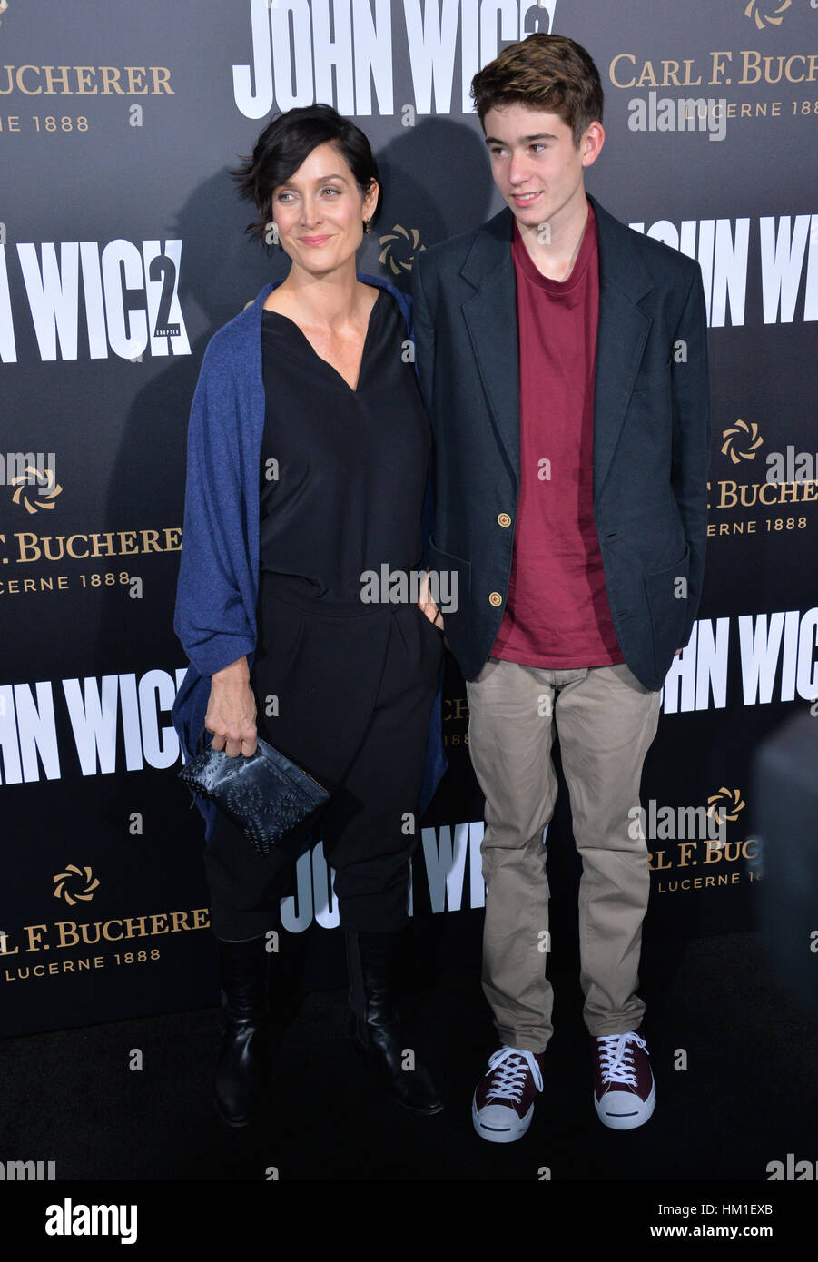Los Angeles, California, USA. 30th January 2017. Actress Carrie-Ann Moss & son Owen Roy at the premiere of 'John Wick Chapter Two' at the Arclight Theatre, Hollywood.  Credit: Sarah Stewart/Alamy Live News Stock Photo
