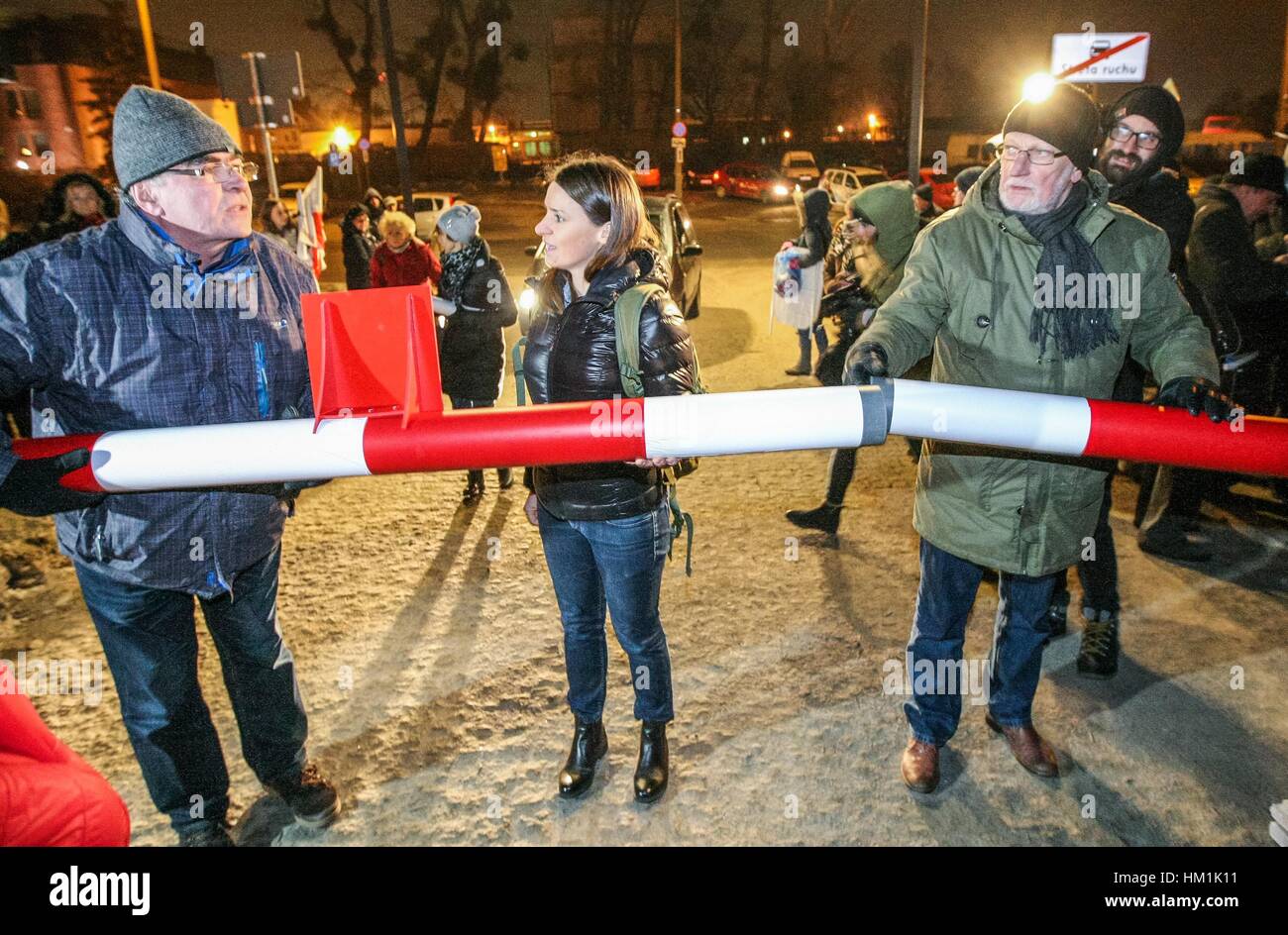 Gdansk, Poland. 31st Jan, 2017. Agnieszka Pomaska (C) Polish parliament member and Lech Kosiak (R) holding symbolic border barrier are seen outside the Second World War Museum on 31 January 2017 in Gdansk, Poland. Protest was organized by KOD movement against Poland's nationalist government plans to reshape the Museum's permanent exhibition into a display more focused on Poland's experience of the conflict. Museum is expected to open to the public on February 2017, is to place the war in broader international context. Credit: Michal Fludra/Alamy Live News Stock Photo