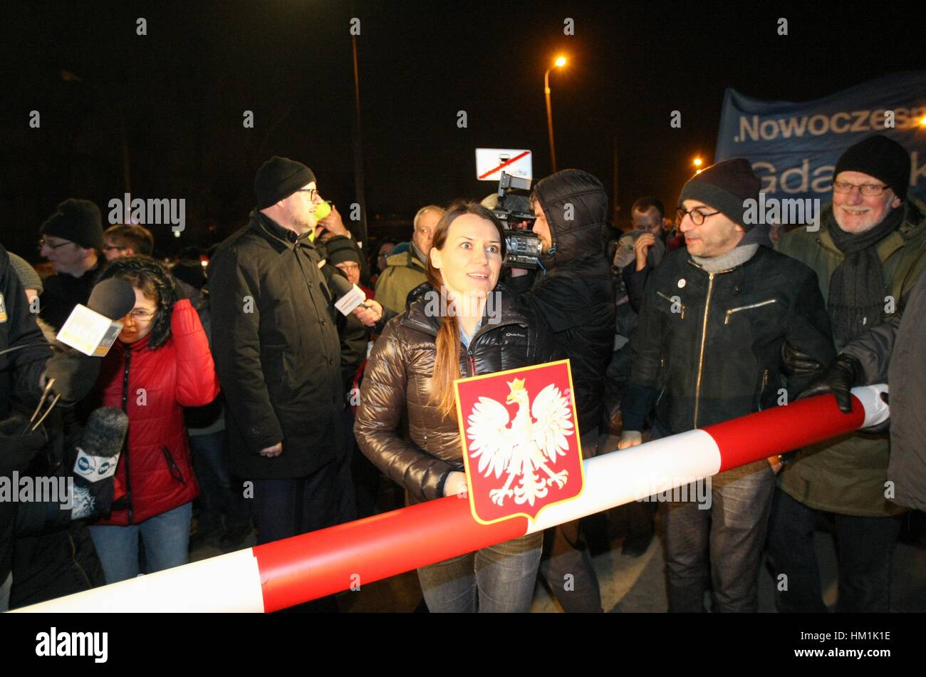 Gdansk, Poland. 31st Jan, 2017. Agnieszka Pomaska (C) Polish parliament member holding symbolic border barrier is seen outside the Second World War Museum on 31 January 2017 in Gdansk, Poland. Protest was organized by KOD movement against Poland's nationalist government plans to reshape the Museum's permanent exhibition into a display more focused on Poland's experience of the conflict. Museum is expected to open to the public on February 2017, is to place the war in broader international context. Credit: Michal Fludra/Alamy Live News Stock Photo