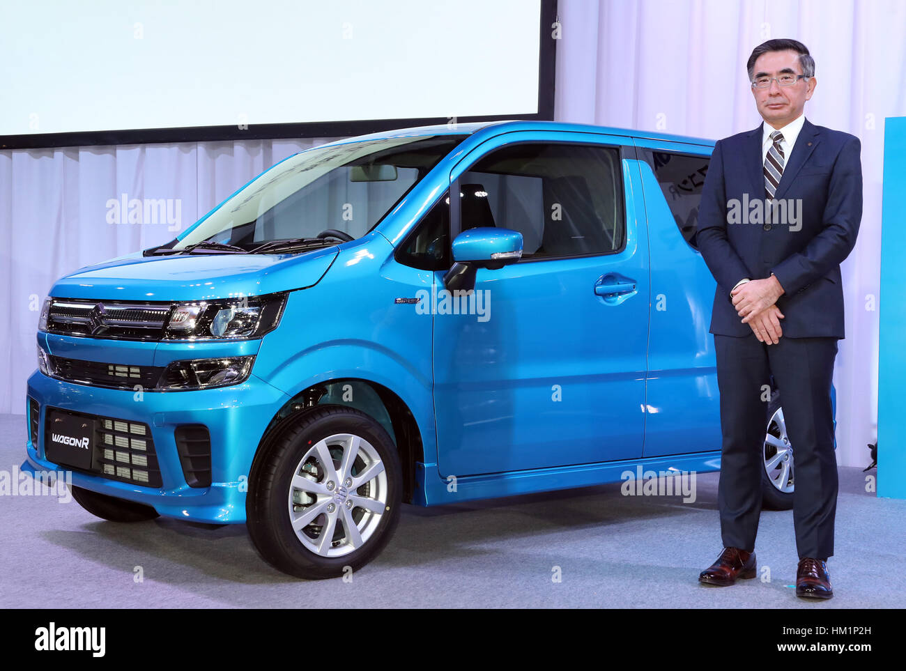 Tokyo, Japan. 1st Feb, 2017. Japan's minicar maker Suzuki Motor president Toshihiro Suzuki displays the mini wagon 'Wagon R' which has 660cc engine or engine/electric-motor hybrid system to drive roomy body in Tokyo on February 1, 2017. The new Wagon R has various safety devices and minicar's first head-up display. Credit: Yoshio Tsunoda/AFLO/Alamy Live News Stock Photo