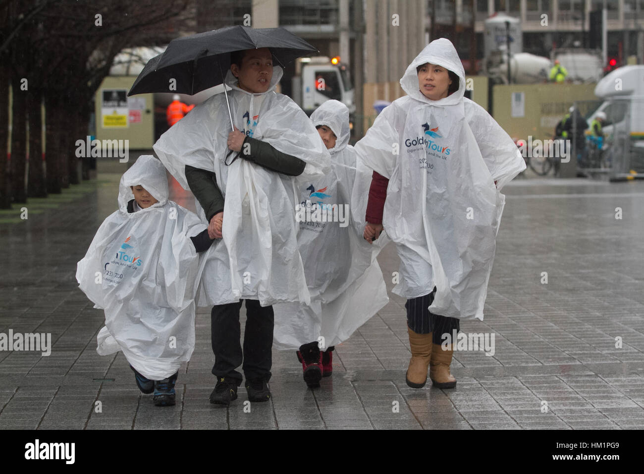 London, UK. 1st Feb, 2017. A family of tourists in Ponchos shelter from the rain on a wet day in London Credit: amer ghazzal/Alamy Live News Stock Photo