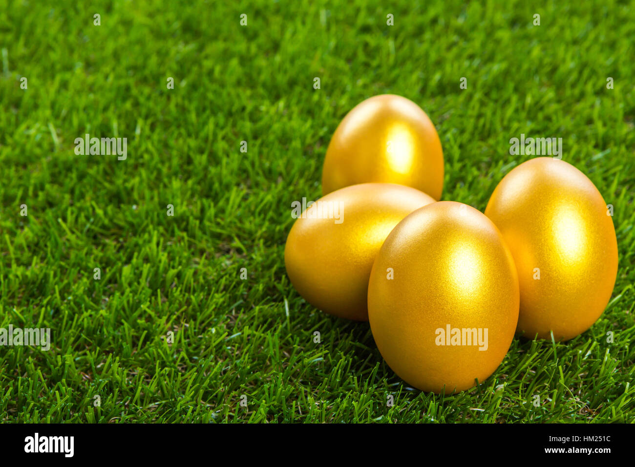 Gold easter egg on a green grass Stock Photo - Alamy