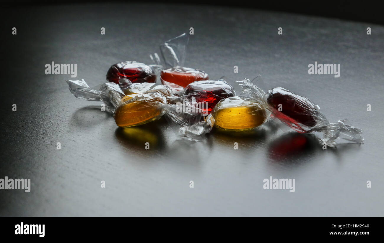 Bobon sugar lollies colorful round glassy glossy sweets orange red Stock Photo Alamy
