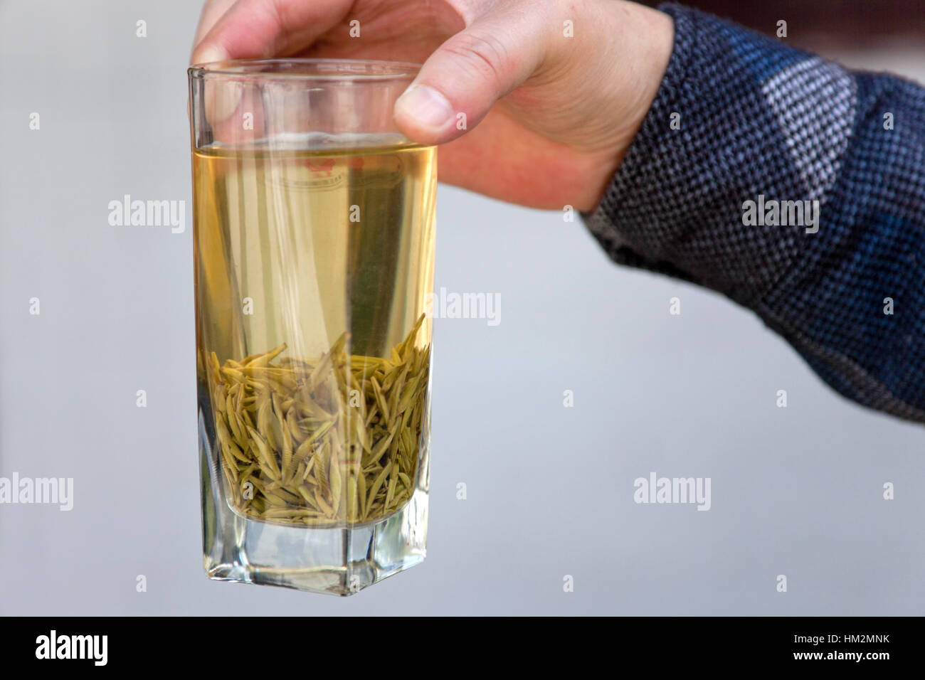 A glass of green tea brewed from tender buds picked during the first tea harvest of the year. Stock Photo