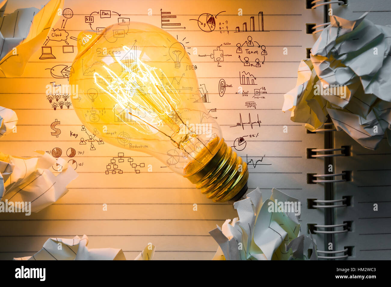 Note book and light bulb with drawing graph on wood table Stock Photo ...