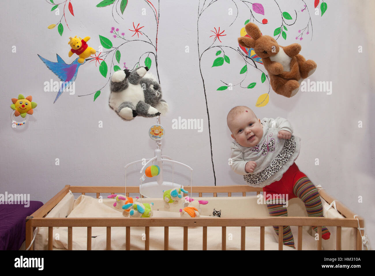 A Baby Levitates From Her Crib With Her Toys In The Air Too Stock