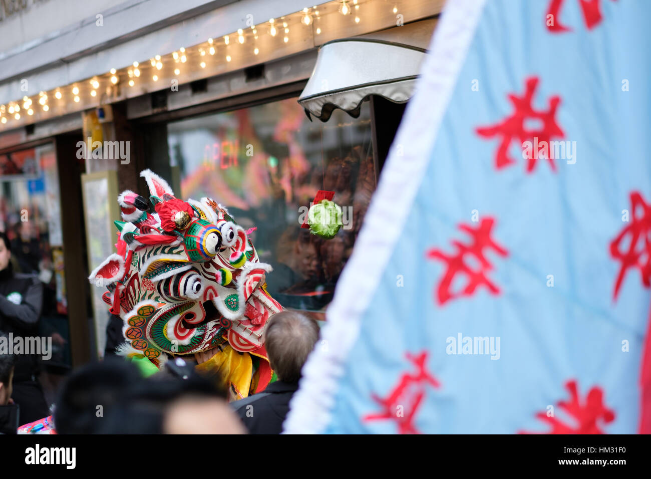 Dragon collects red envelopes in Chinatown, London, UK. Chinese New Year 2017 (year of the rooster) Stock Photo