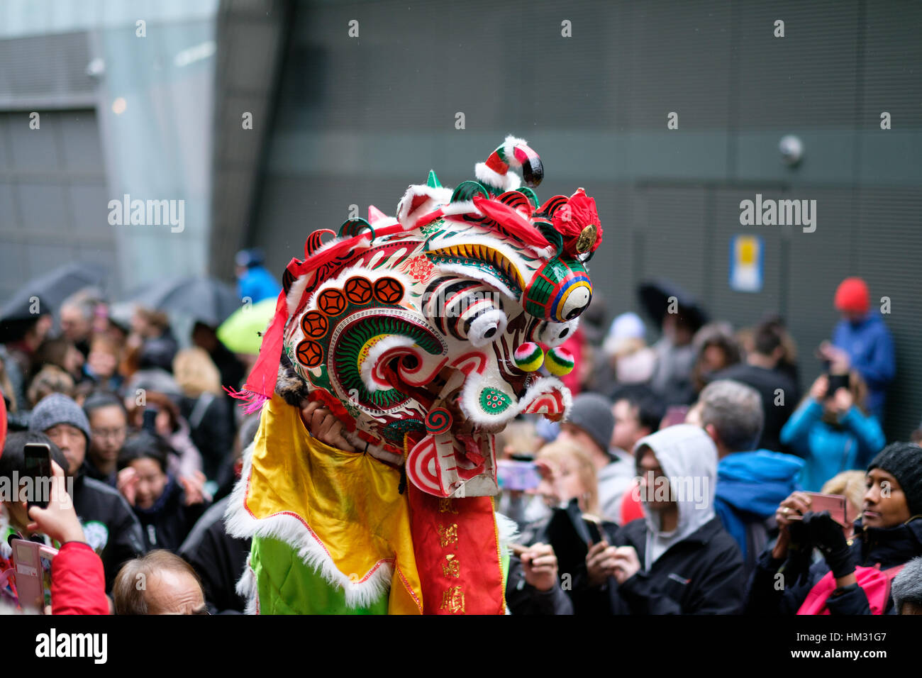 Dragon collects red envelopes in Chinatown, London, UK. Chinese New Year 2017 (year of the rooster) Stock Photo