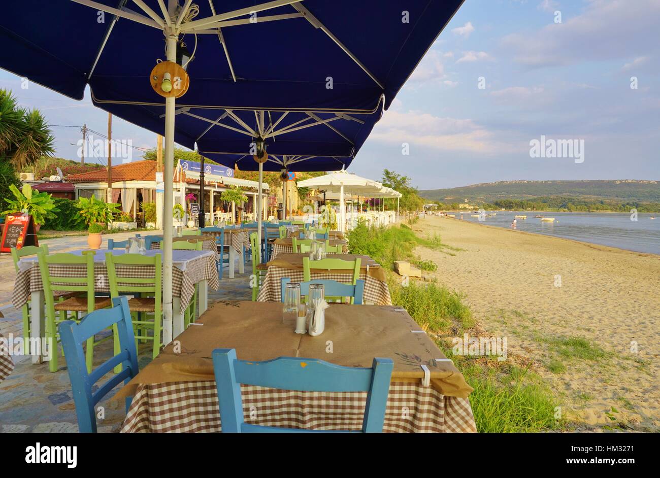 The beach town of Gialova in Messinia in the Peloponnese region of Greece near Pylos is lined with traditional tavernas Stock Photo