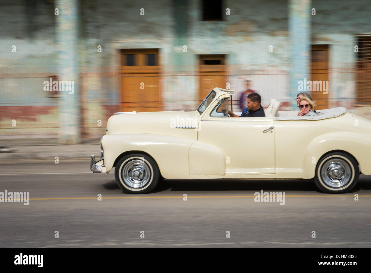 Driving in an old classic American convertible car in old Havana, Cuba Stock Photo