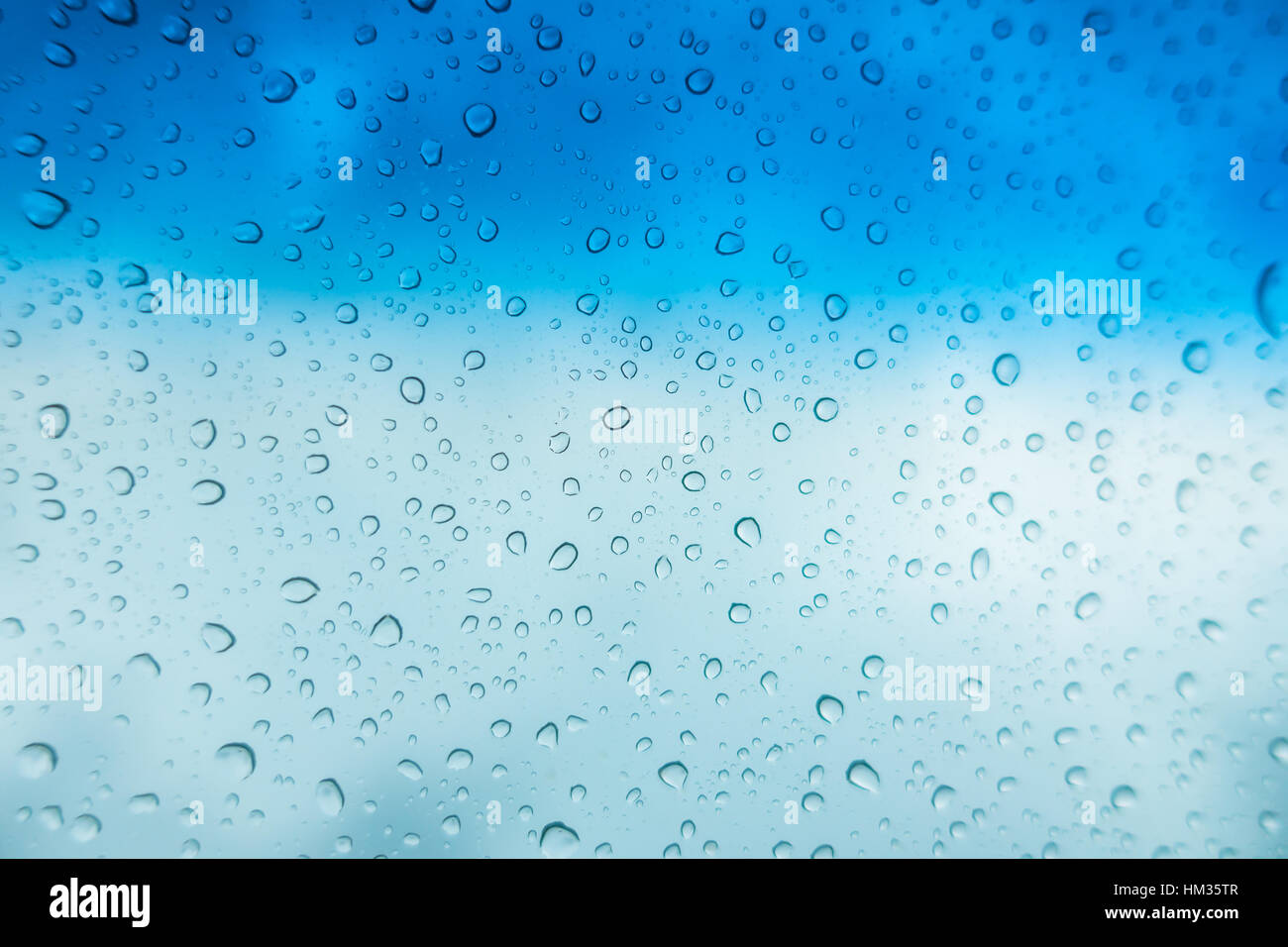 Drops of water on glass window over blue sky Stock Photo - Alamy