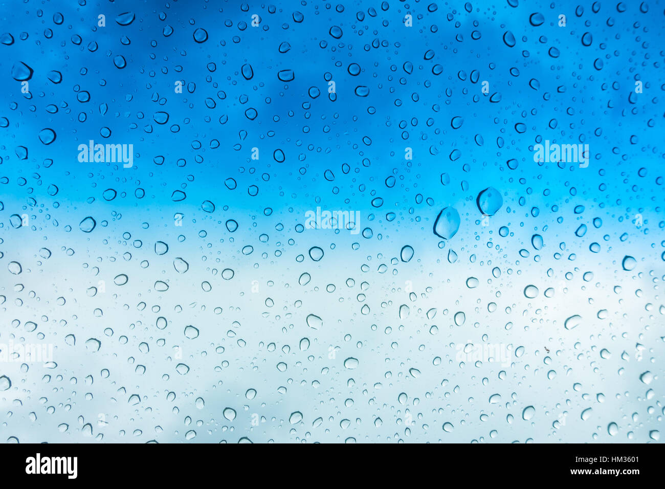 Drops of water on glass window over blue sky Stock Photo - Alamy