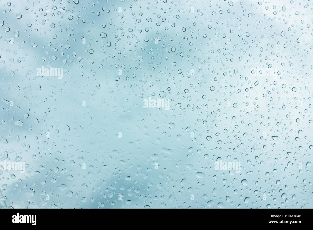 Drops of water on glass window over blue sky Stock Photo - Alamy
