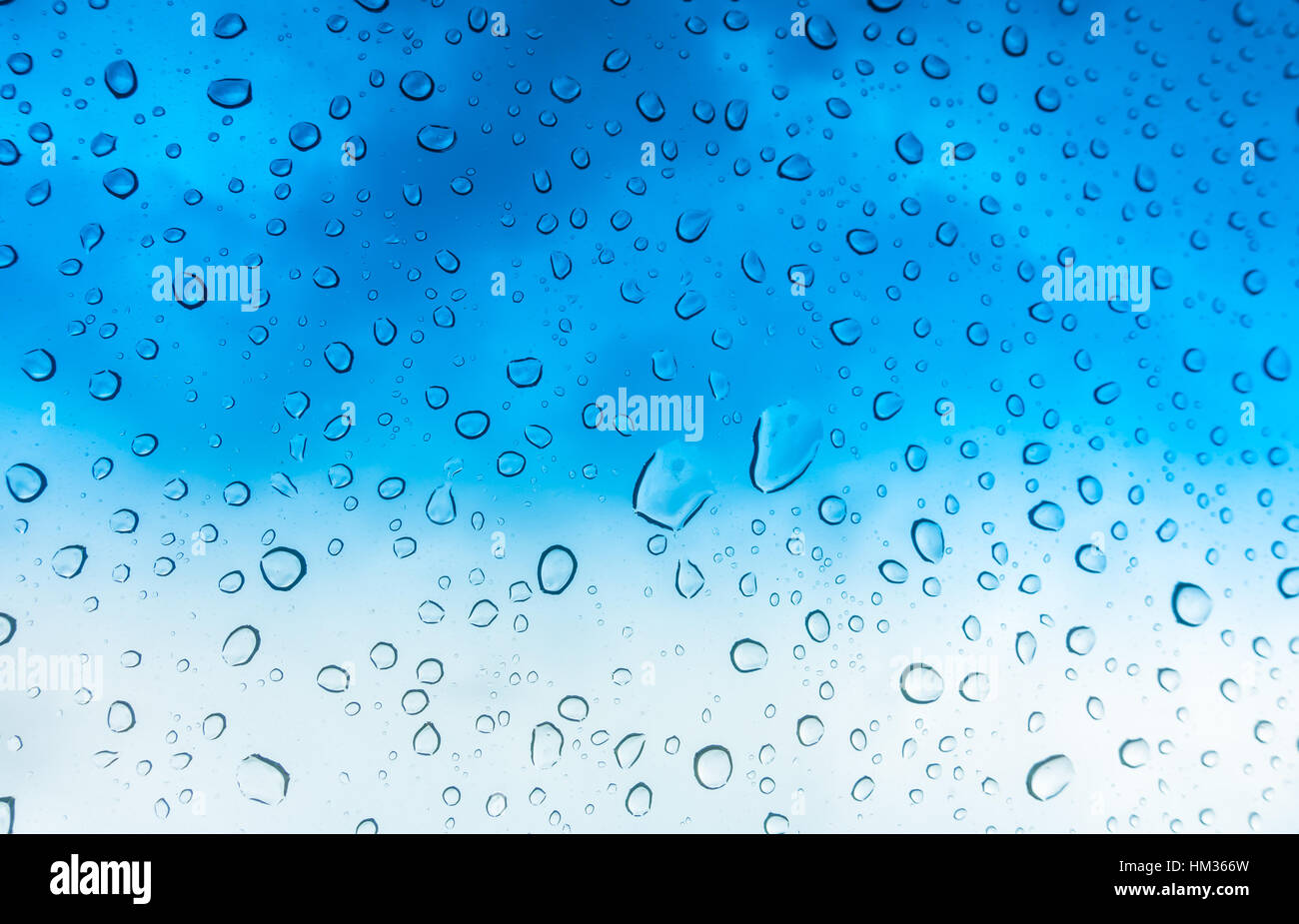 Drops of water on glass window over blue sky Stock Photo - Alamy