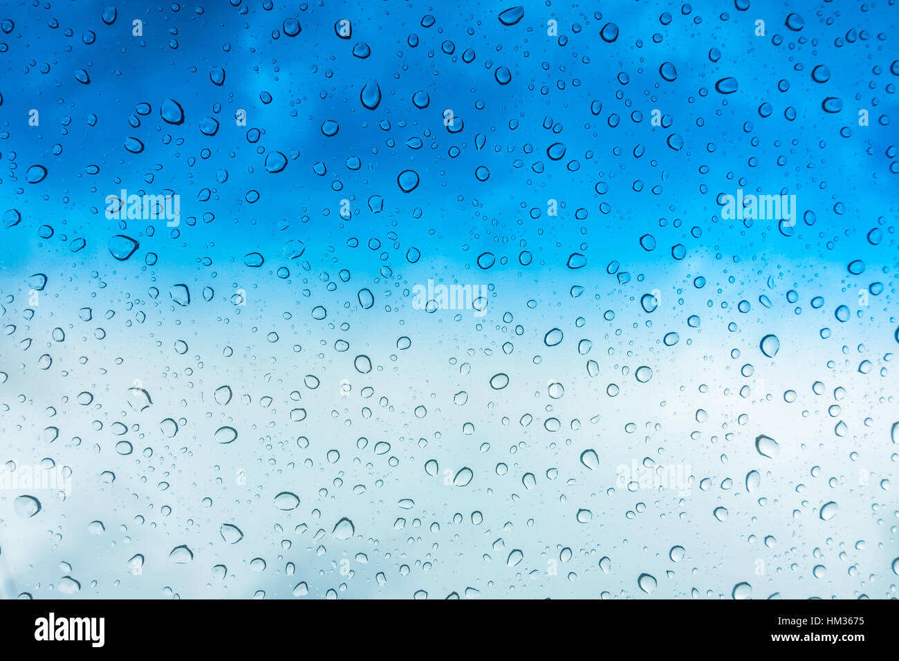 Drops of water on glass window over blue sky Stock Photo - Alamy