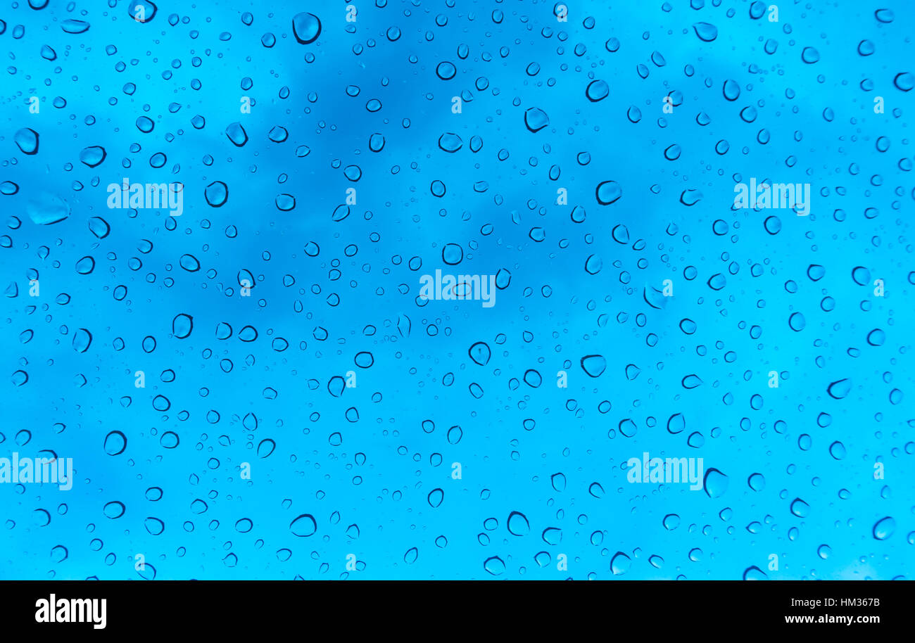 Drops of water on glass window over blue sky Stock Photo - Alamy