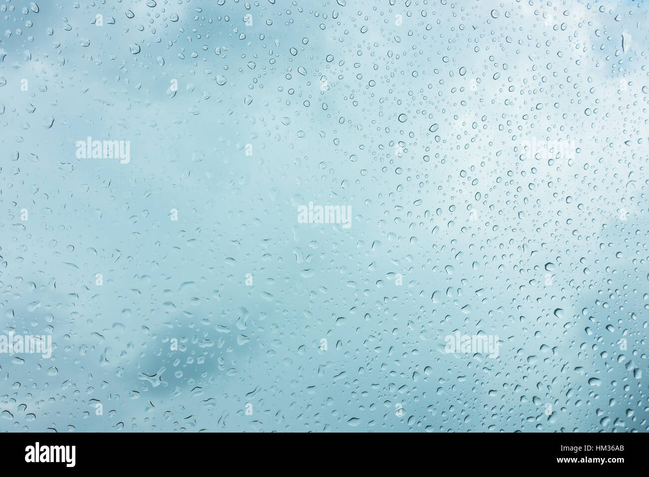Drops of water on glass window over blue sky Stock Photo - Alamy