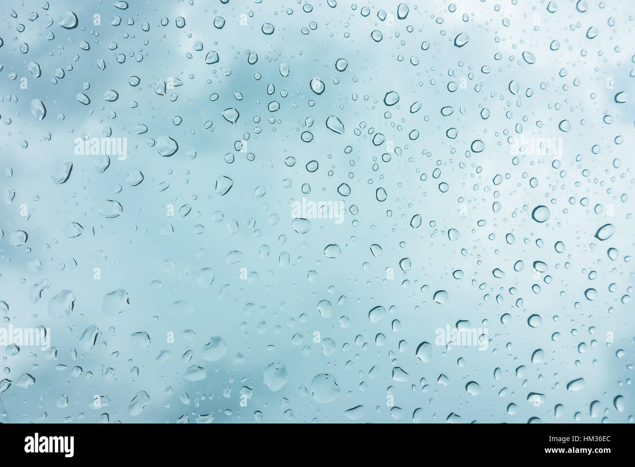 Drops of water on glass window over blue sky Stock Photo - Alamy