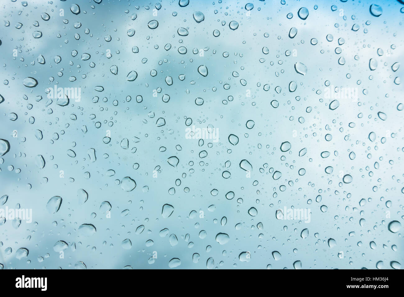 Drops of water on glass window over blue sky Stock Photo - Alamy