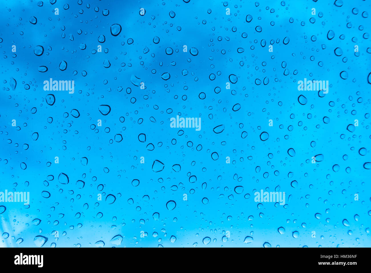 Drops of water on glass window over blue sky Stock Photo - Alamy