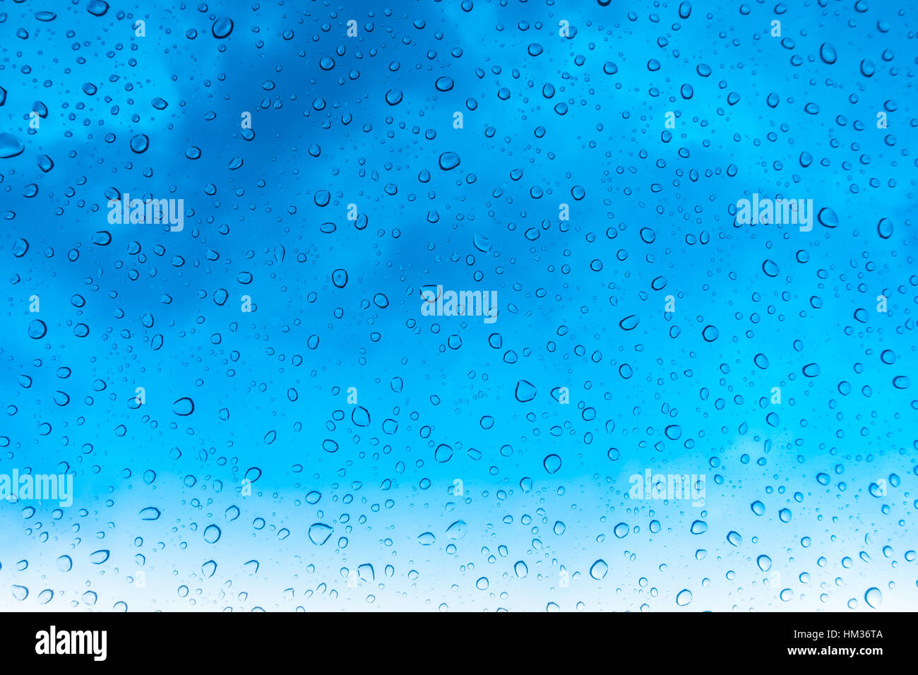 Drops of water on glass window over blue sky Stock Photo - Alamy