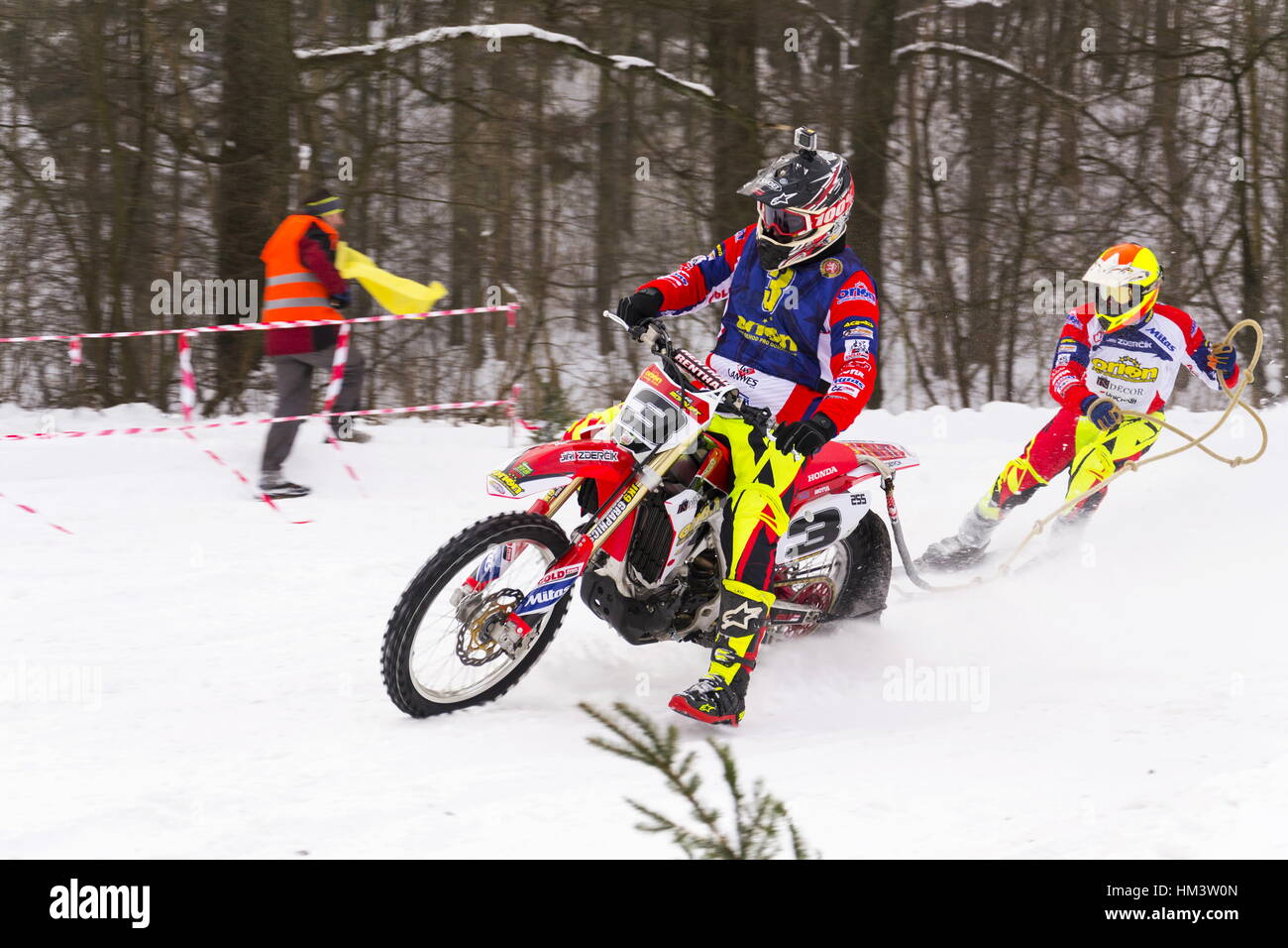 Motorcycle skijoring racers ride on track of Czech championship competition on January 29, 2017 in Klasterec nad Orlici, Czech republic. Stock Photo