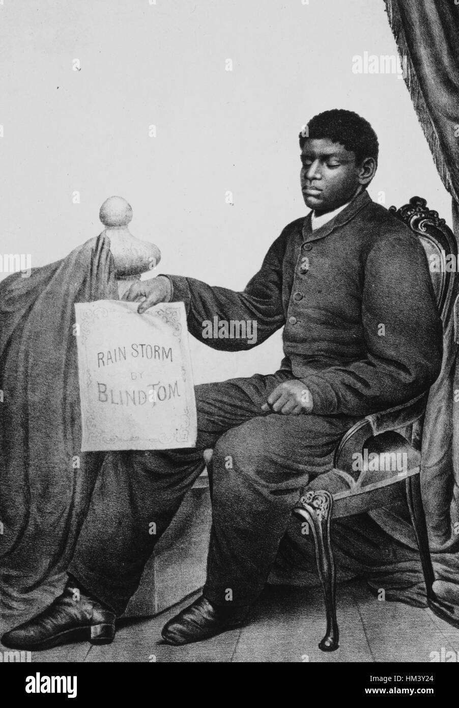 Thomas Wiggins, the musical prodigy known as Blind Tom, sitting in a chair and holding a sign that reads Rain Storm by Blind Tom, 1879. From the New York Public Library. Stock Photo