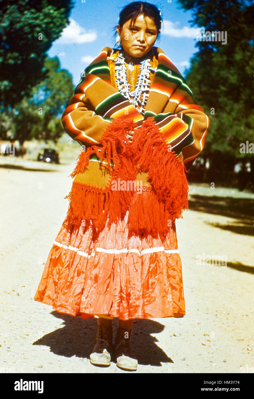 Portrait of a young girl wearing a traditional poncho and skirt