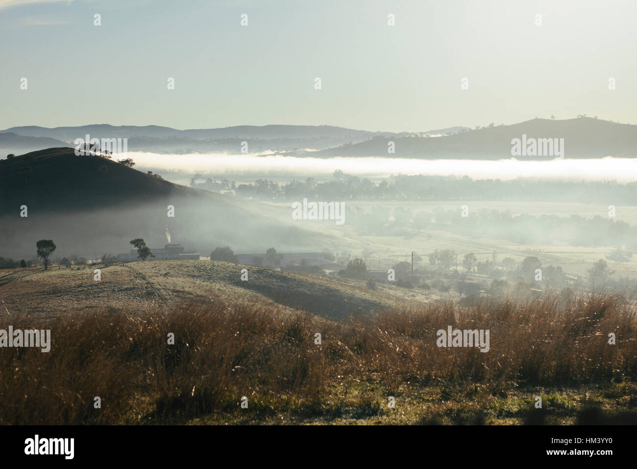 View of the early morning fog in the valley in Gundagai NSW from above the town Stock Photo