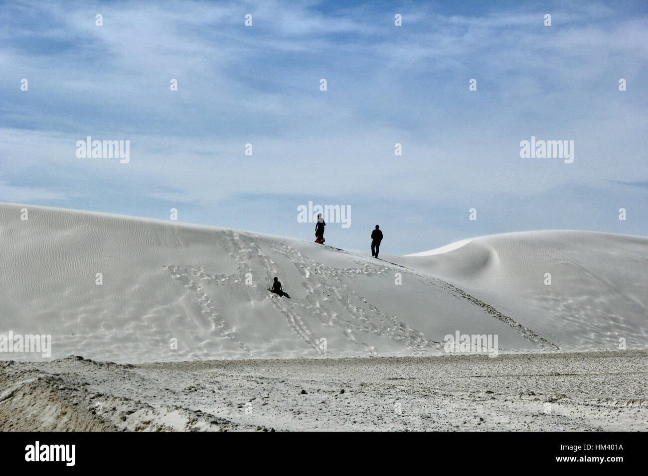A family enjoying White Sands National Monument in Alamogordo, New Mexico. It is world's largest gypsum dunefield. Stock Photo