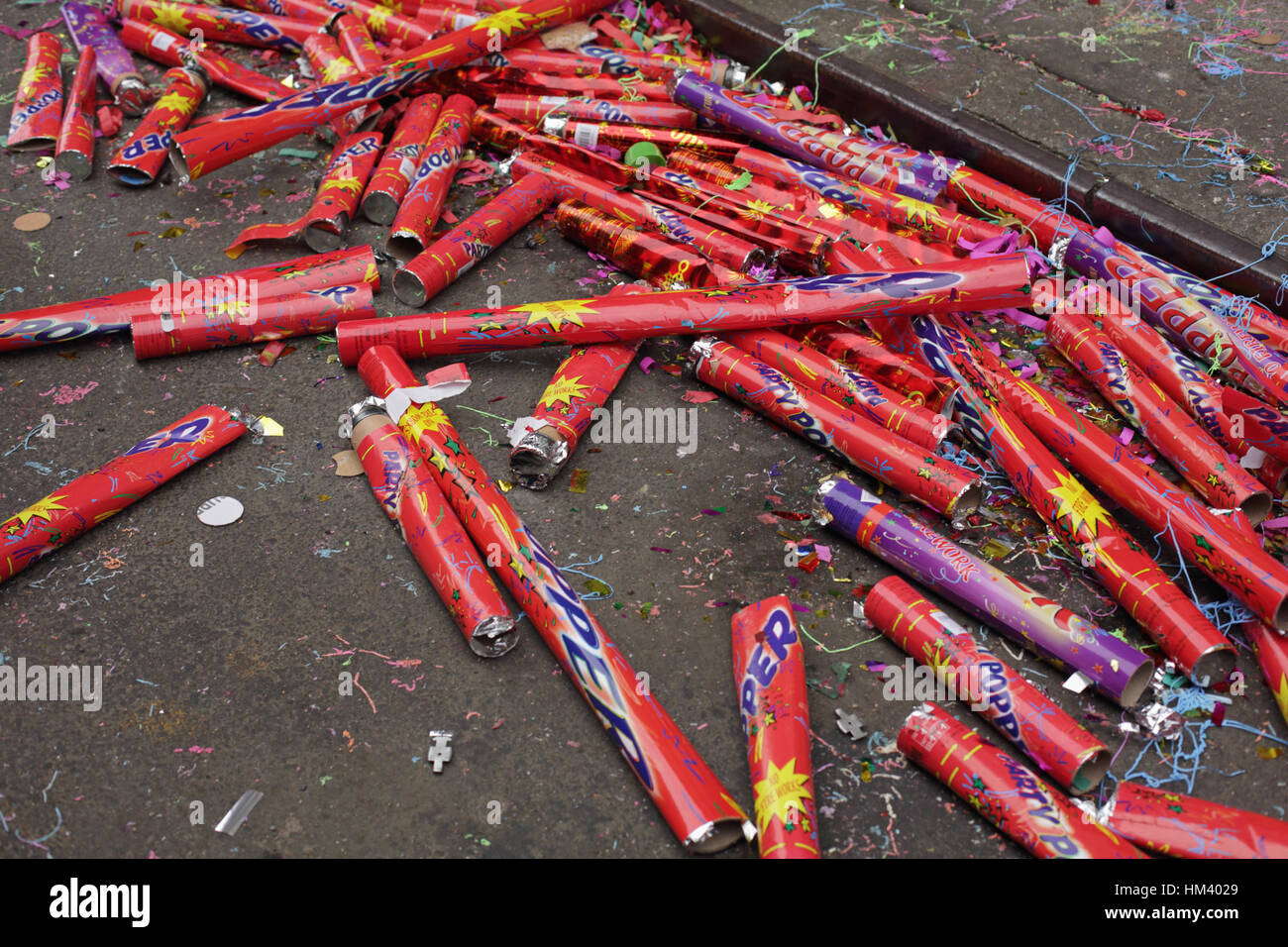 Spent giant party poppers, confetti and glitter litter a NYC Chinatown street on the first day of the Chinese New Year Stock Photo