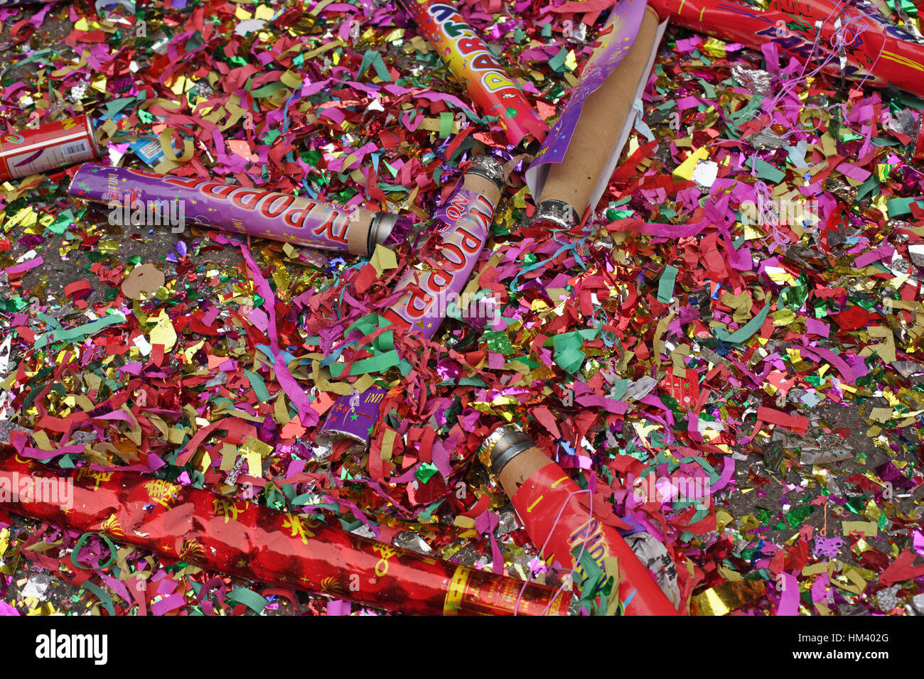 Spent giant party poppers, confetti and glitter litter a NYC Chinatown street on the first day