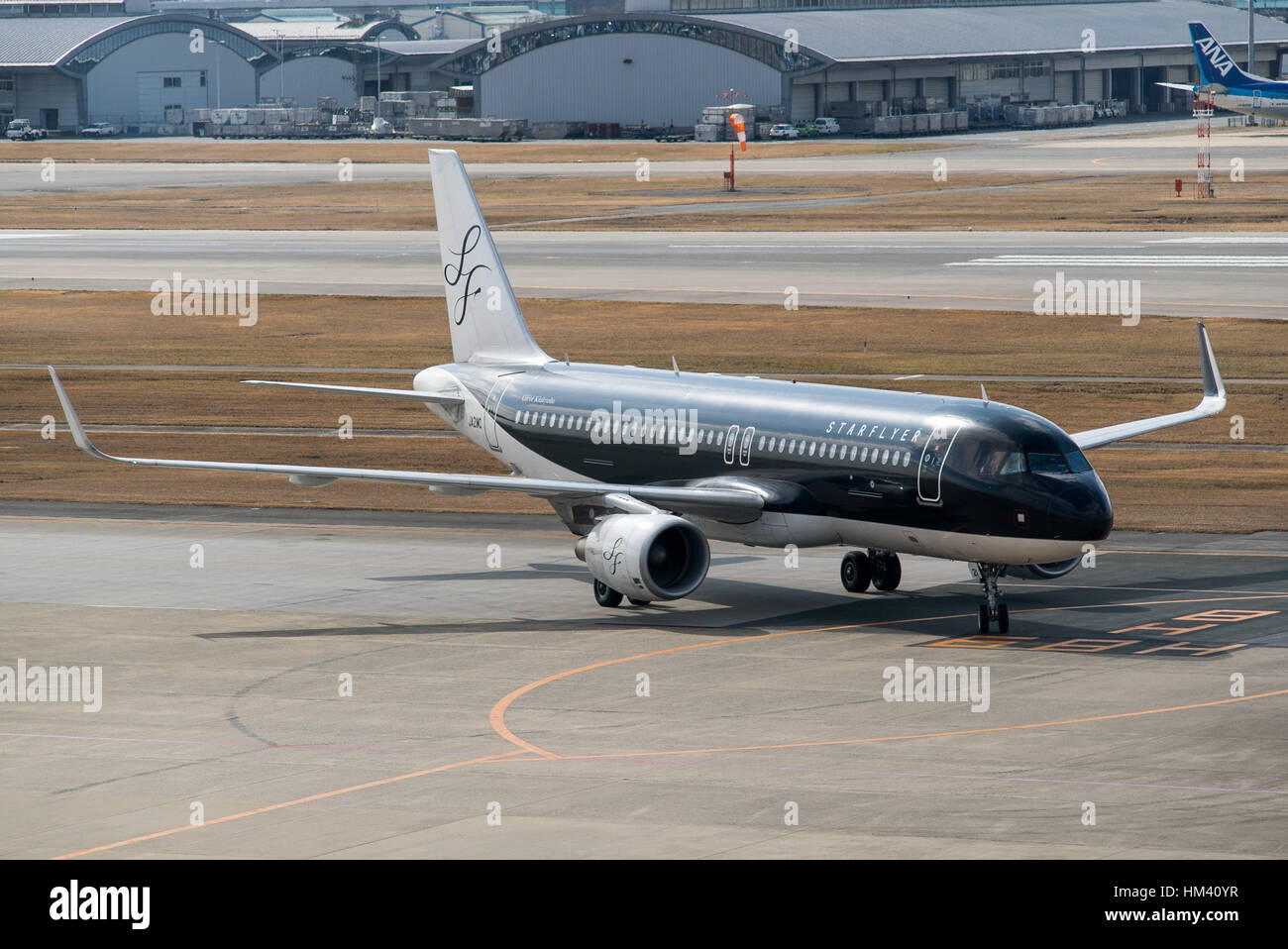 a Starflyer jet turns onto the gate at Fukuoka Airport, Japan Stock Photo