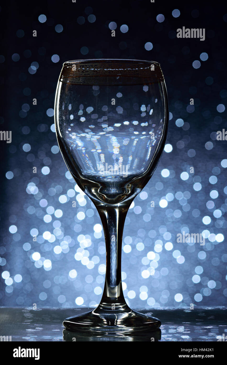 empty glass for wine with gold top on bokeh background Stock Photo