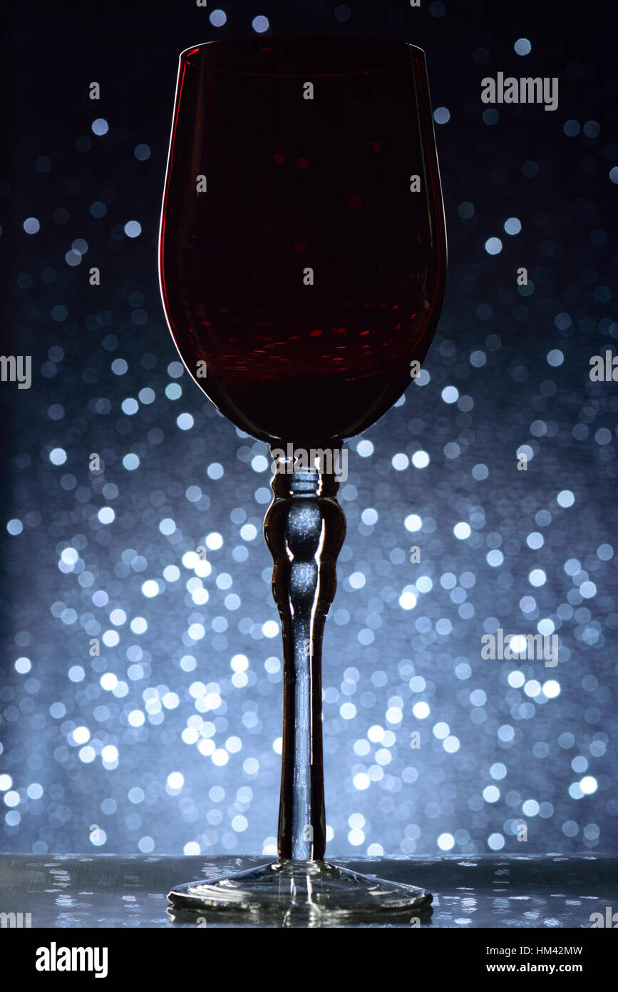 red wine tall glass on blue bokeh background Stock Photo