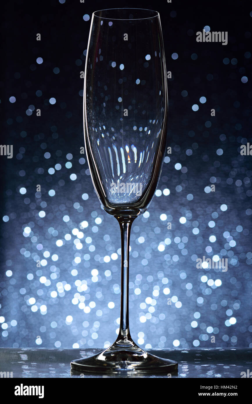 empty tall wine glass on blue bokeh background Stock Photo