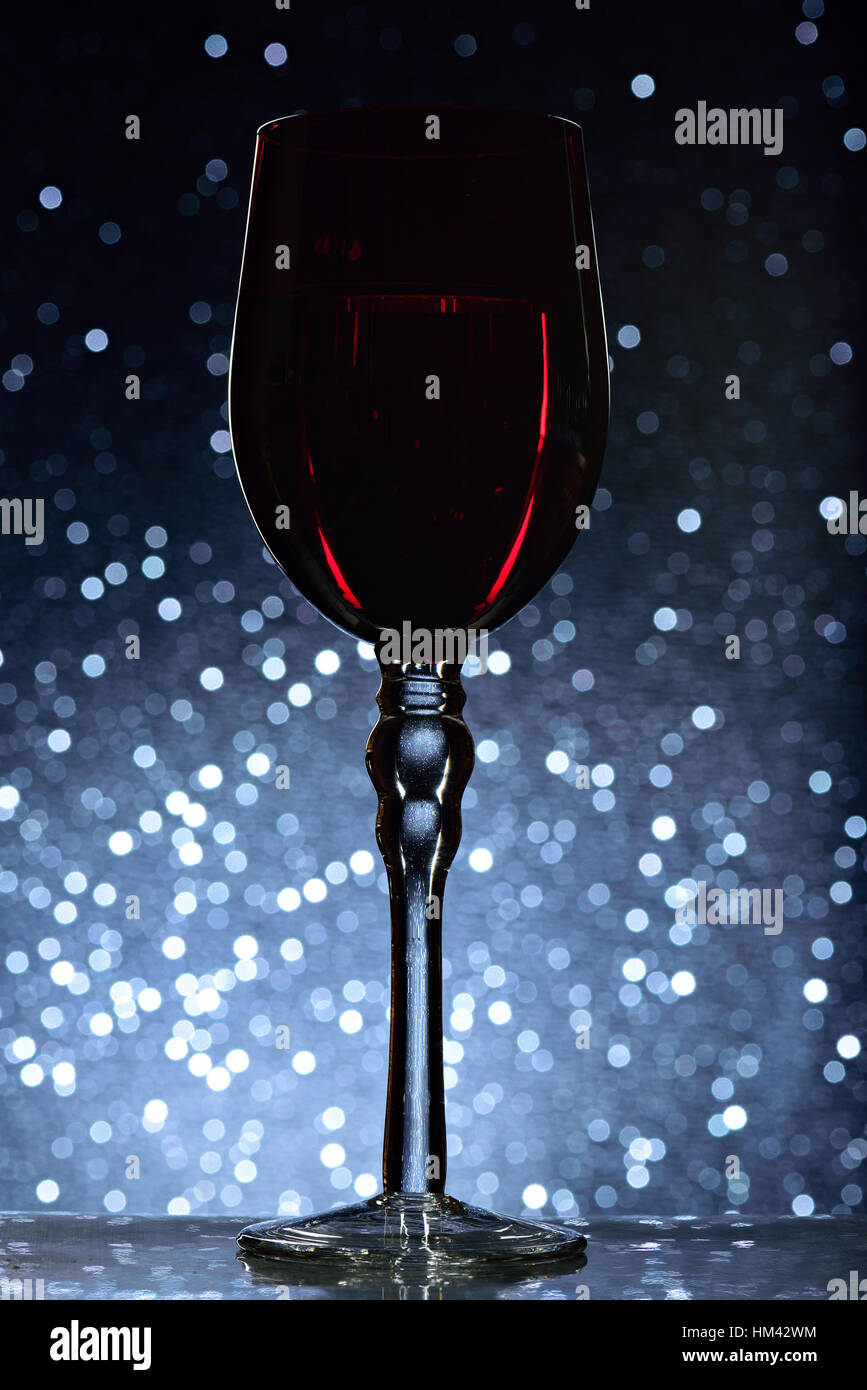 red wine glass on blue dots bokeh background Stock Photo