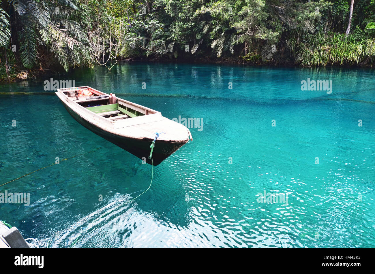 Floating boat on Labuan Cermin Lake Stock Photo