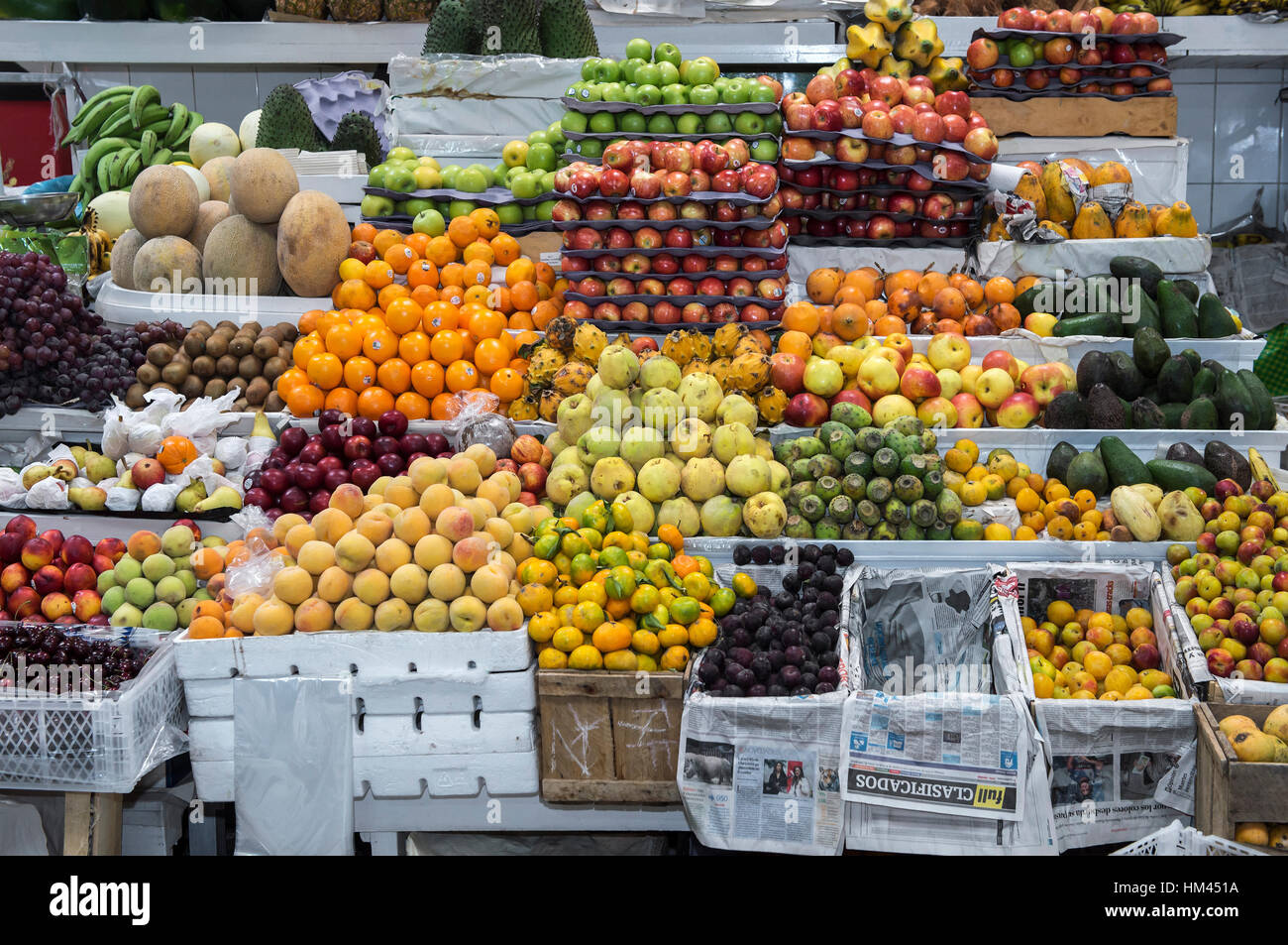 Colorful fruit stand with exotic fruits on display, Inaquito Market food court, Quito, Ecuador Stock Photo