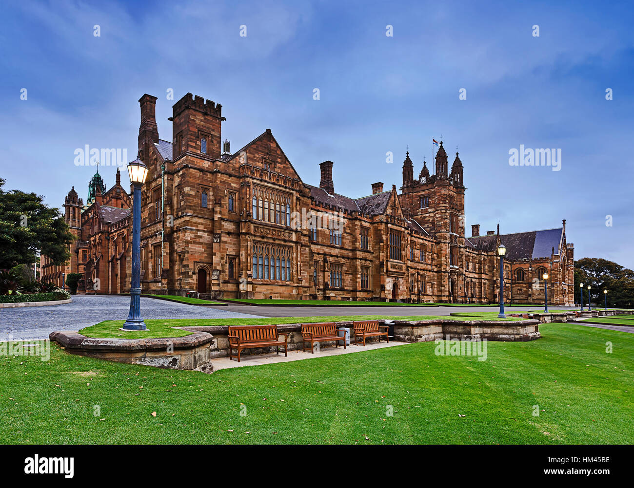 Historic main building of University of Sydney from green grass of lawn