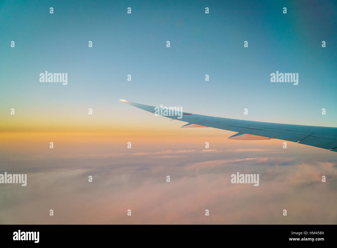 Wing of an airplane flying above the clouds Stock Photo - Alamy