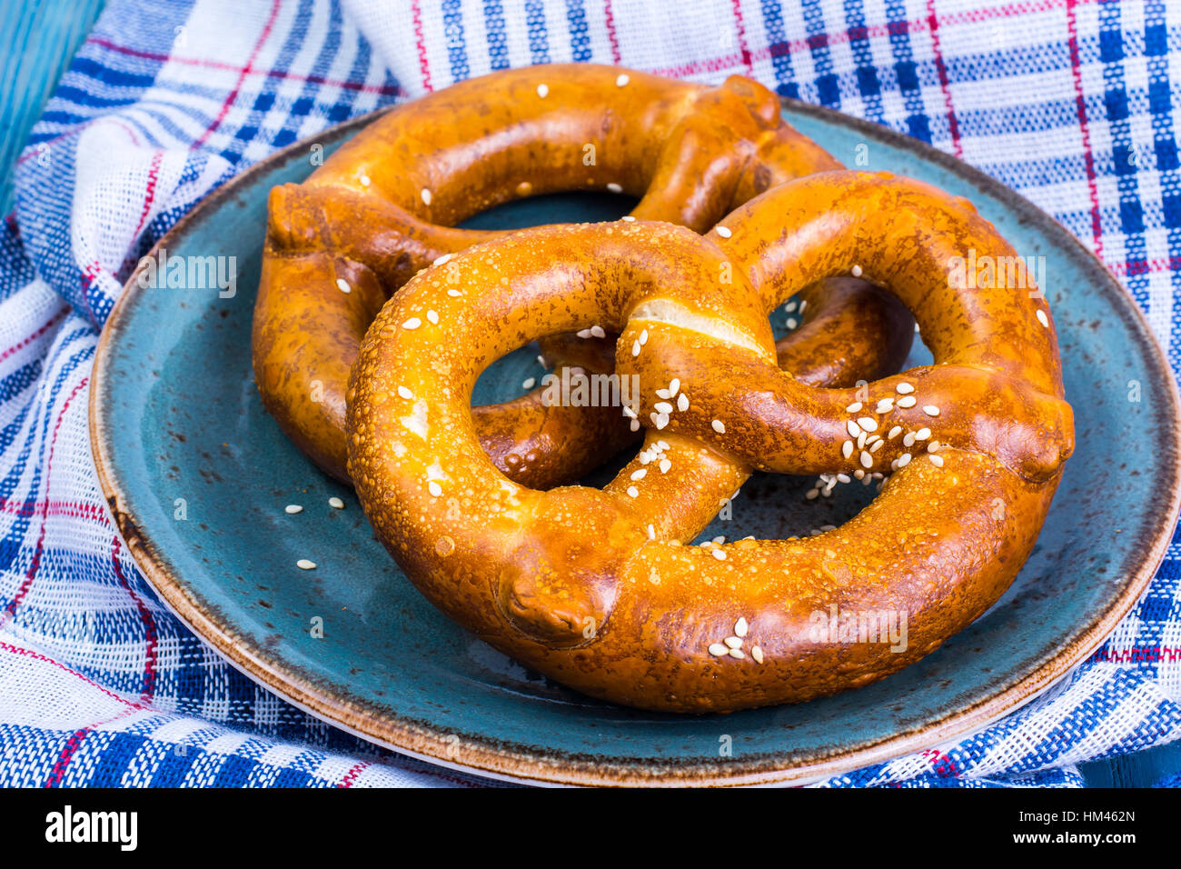 Freshly baked pretzels with salt and cheese on a blue background Stock ...