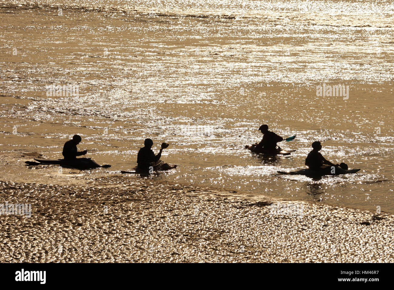 Surfers and water sports enthusiasts on the River Severn Bore, Newnham