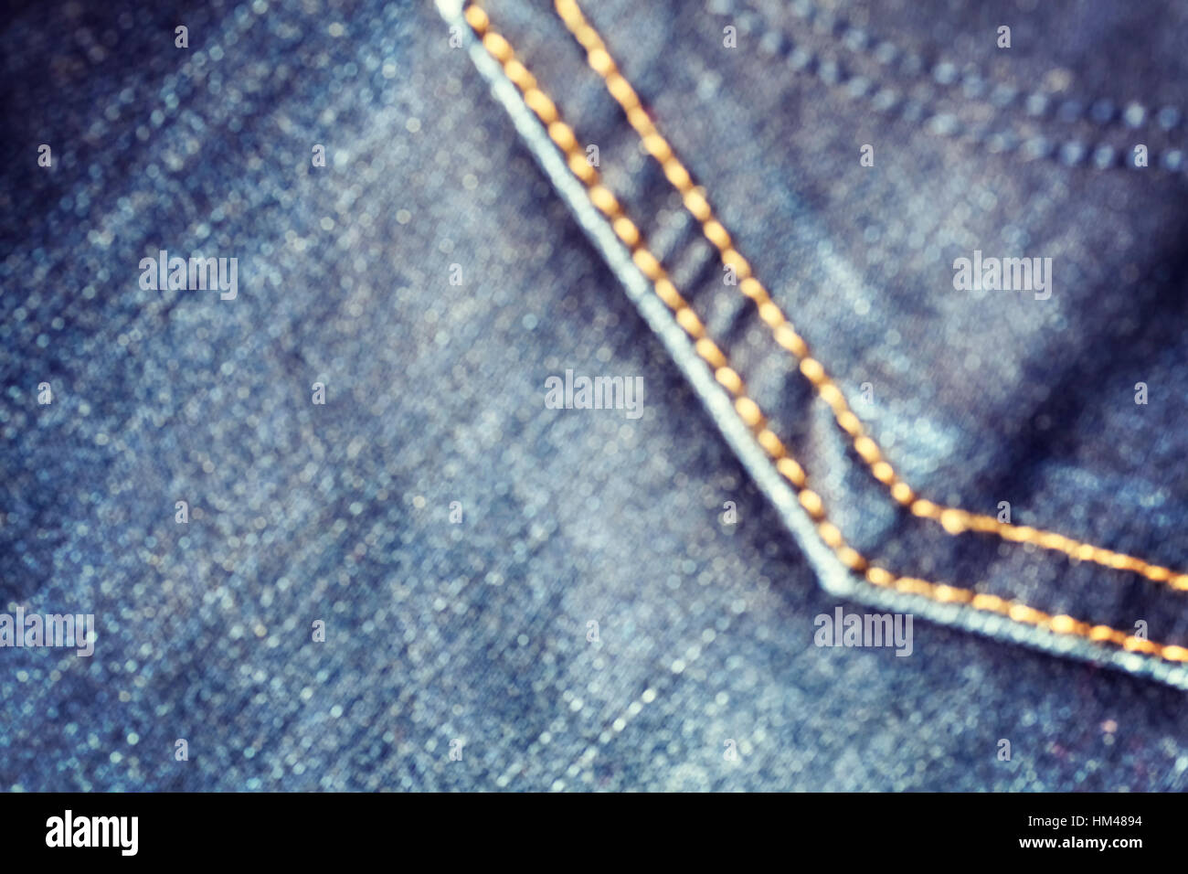 Blurred close up picture of blue jeans fabric with stitch, abstract background. Stock Photo